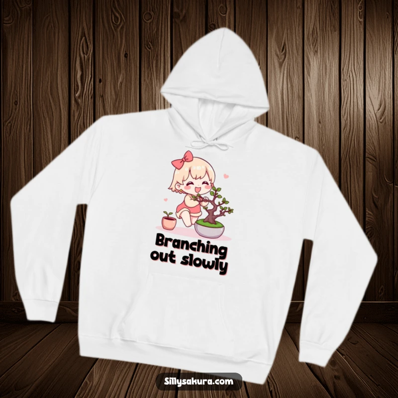 Funny Kawaii Hoodie. A cute character joyfully tends to a miniature bonsai tree, perfect for cozy, nature-loving days.