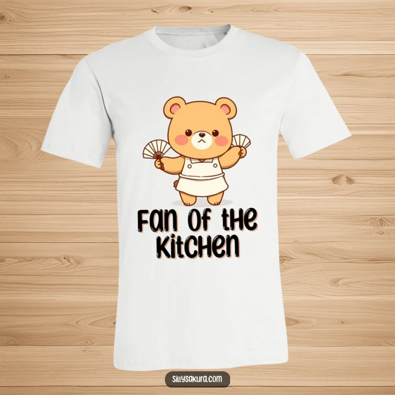 Funny T-Shirt featuring a tiny bear character wearing an apron, enthusiastically waving a fan, embodying a warm but cool chef.